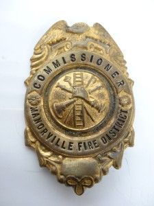 This is a Vintage Commiss ioner Manorville Fire District Badge