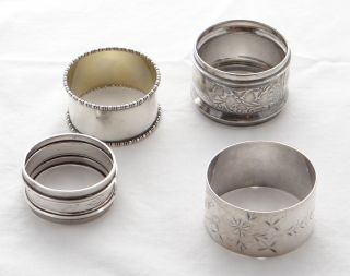 These are four unmatched silver napkin rings. Here are the details:
